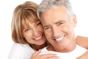 Older Couple in White Shirts Embracing and Smiling