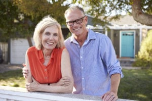 Portrait Of Mature Couple Looking Over Fence