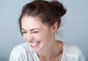 Brunette Female Squinting and Smiling